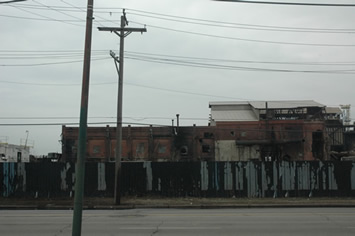 Above photograph of industrial ruins on S. Torrance Ave in Chicago, March 2007: The massive loss of manufacturing jobs because of globalization has left huge stretches of Chicago (such as several miles along S. Torrance Ave., above) with the ruins of industrial plants whose jobs have been shipped overseas, first to places like Mexico and now to China, where wages and working conditions for manufacturing jobs are the closest thing to mass slavery in the world today. The promotion of “free trade” by both the Democratic administration of Bill Clinton and the Republicans under Ronald Reagan, George H. W. Bush, and George W. Bush have left many American cities in worse shape than Chicago. Instead of blaming the incompetence of executives of the steel industry (above) and others in power for the decline of American competitiveness in the world, as “The Shock Doctrine “ shows, the blame is placed on industrial workers, unions, and urban schools. Chicago’s corporate “school reform” is one of the local manifestations of the Shock Doctrine in action. Substance photo by George N. Schmidt.